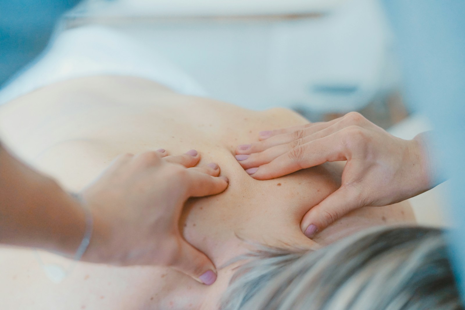 Close-up of a therapist providing a hands-on back massage